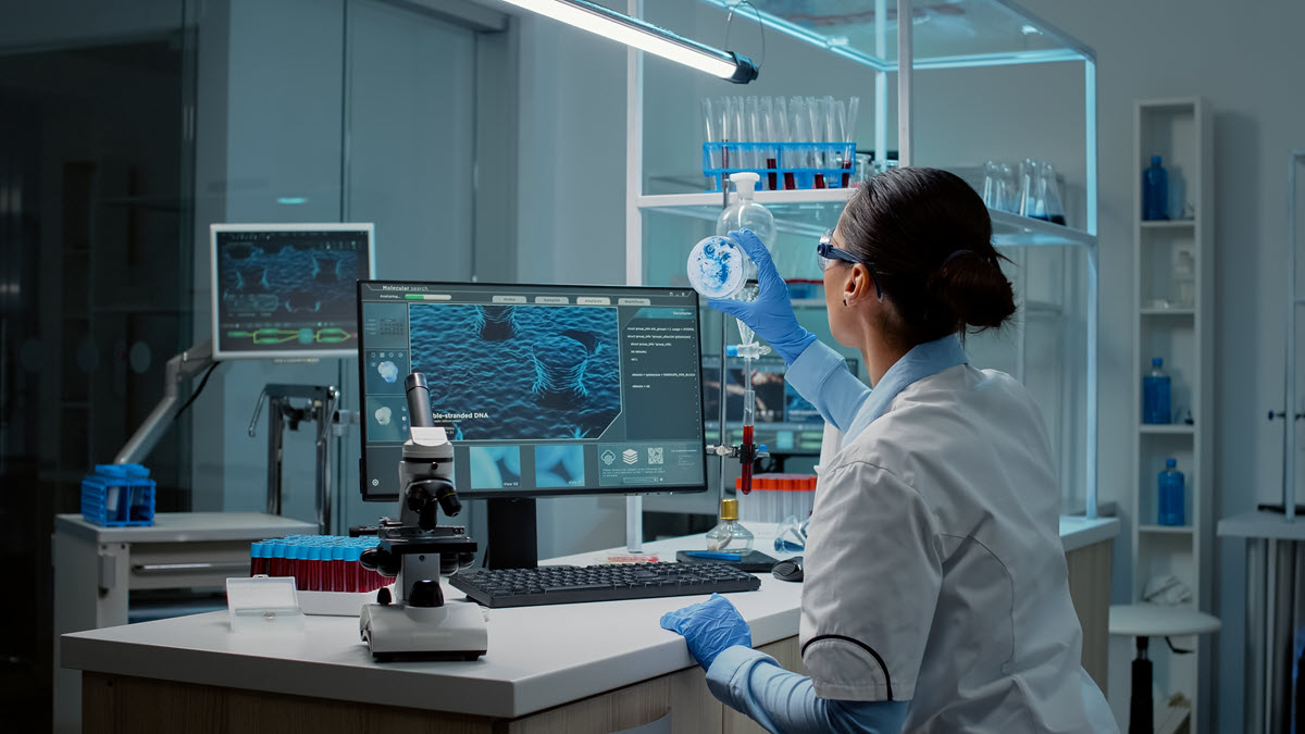 Scientist in a laboratory looking at the research of DNA samples